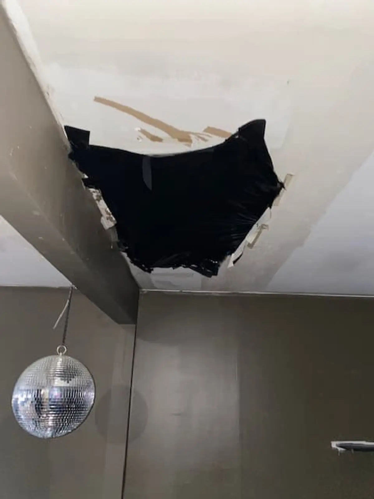 Selling a house as-is in Middle Island: hole broken through a ceiling near a beam